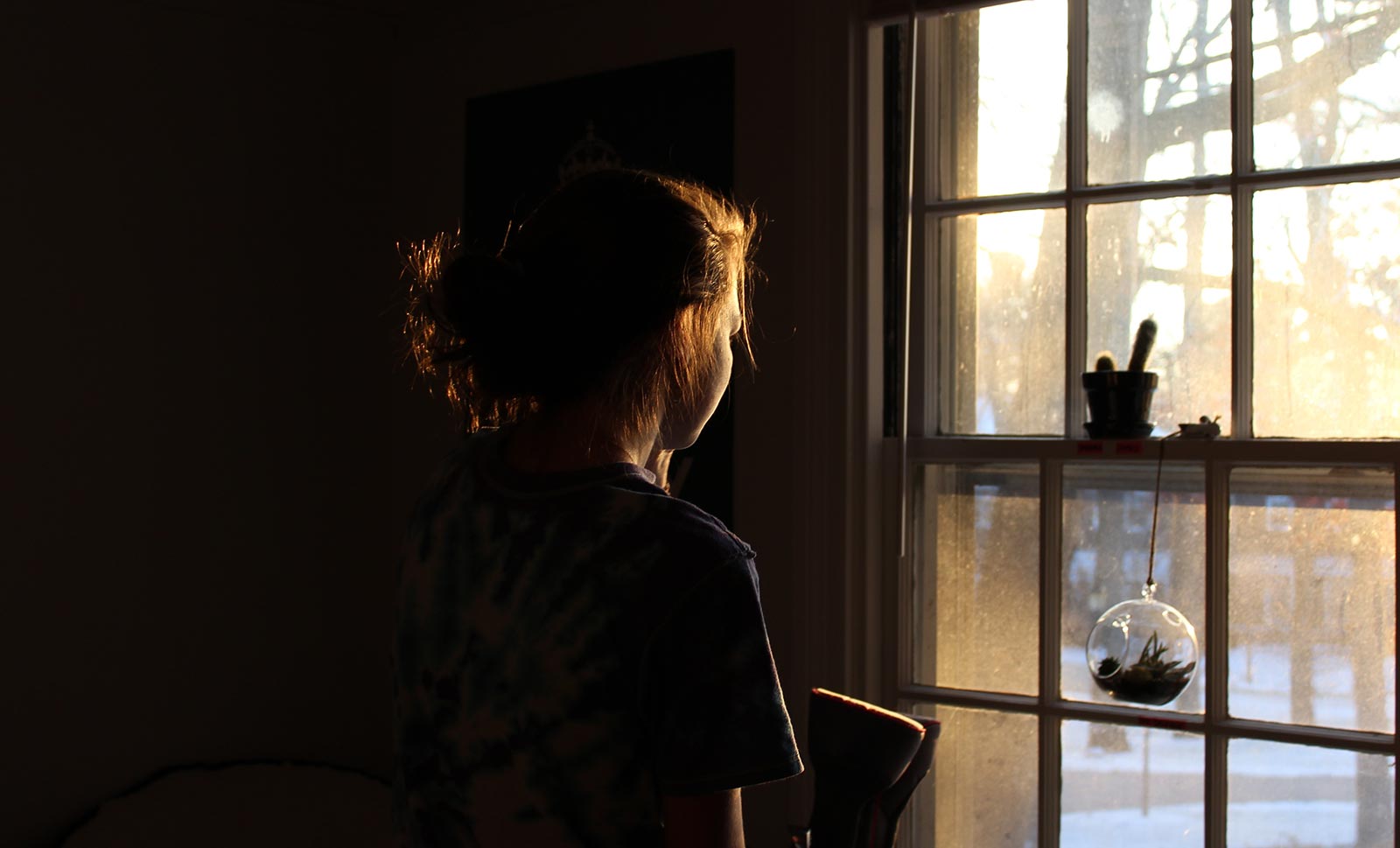 female looking out window - fertility issues